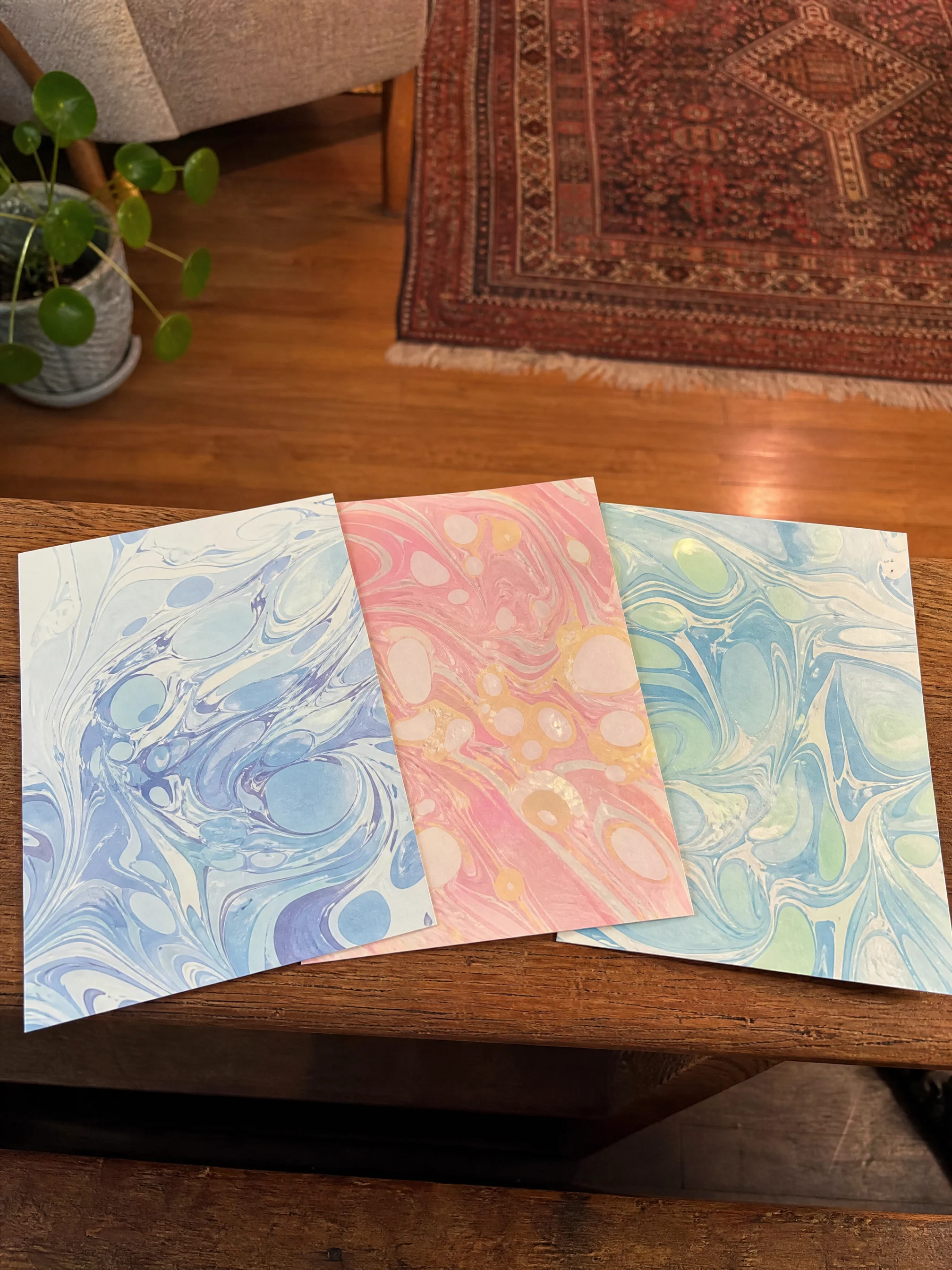 Three finished suminagashi marbled cards ready to ship